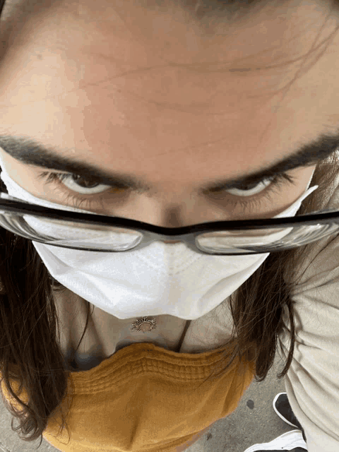 a close up of a person wearing a face mask