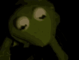 kermit the frog has a syringe in his mouth .