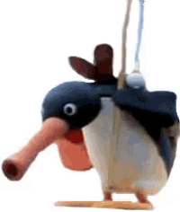 a toy penguin with a long beak is hanging from a rope