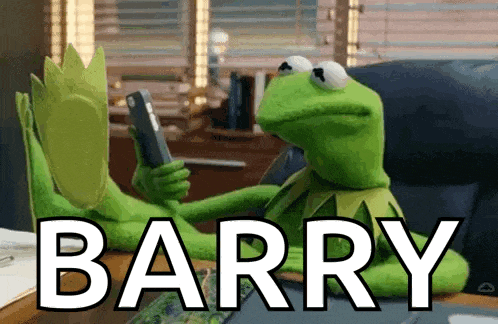 kermit the frog is sitting at a desk holding a cell phone and the word barry is on the table in front of him