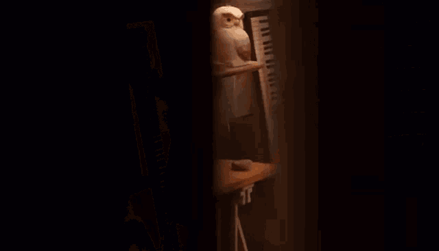 a woman sits in front of a keyboard in a room