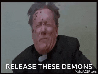 a priest with bullet holes in his face and the words `` release these demons '' written below him .