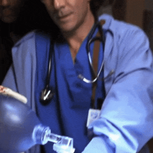a doctor with a stethoscope around his neck is holding a bottle of water
