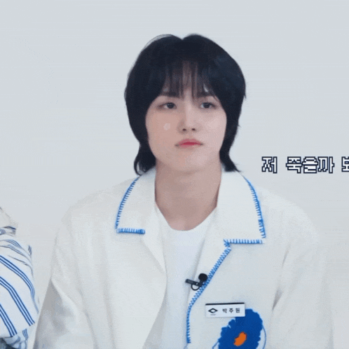 a person wearing a white jacket has a name tag that says ' eee ' on it