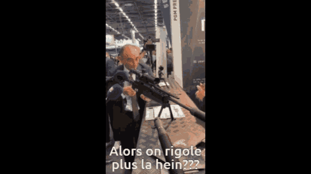 a man in a suit and tie is talking to another man in a room with the words alors on rigole plus la hain