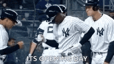 a group of new york yankees baseball players are standing next to each other on the field .