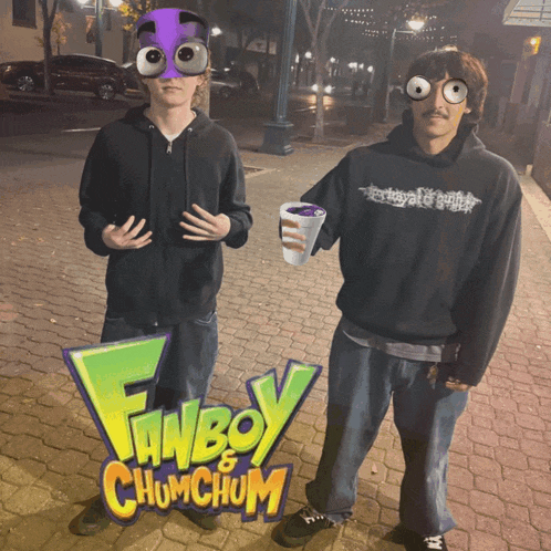 two men are standing in front of a fanboy chumchum sign