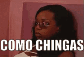 a woman wearing sunglasses and a white shirt with the words como chingas written on the bottom .