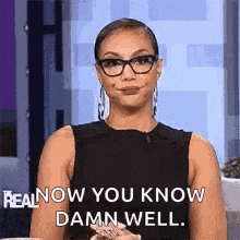 a woman wearing glasses is smiling and saying `` real now you know damn well '' .