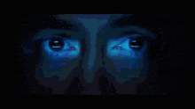 a pixelated image of a man 's face with a blue background