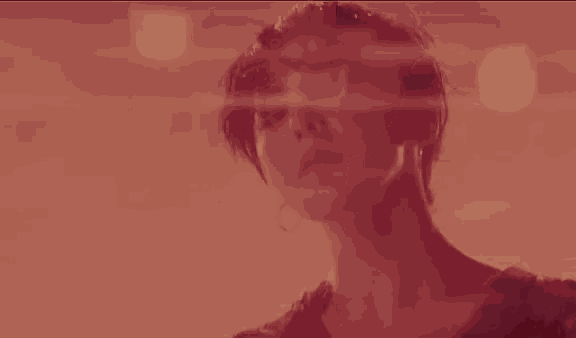 a close up of a woman 's face in a blurry photo .