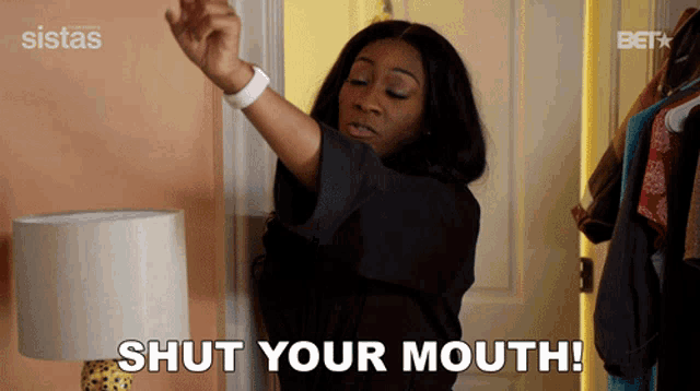 a woman says shut your mouth while standing in front of a closet