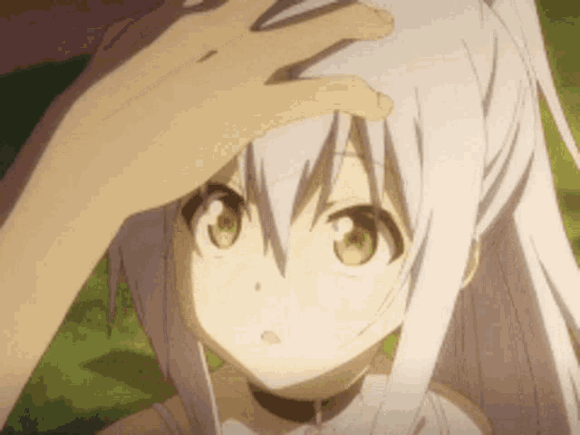 a close up of a person touching a girl 's head with their hand