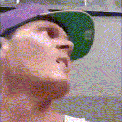 a man wearing a purple hat and a green hat