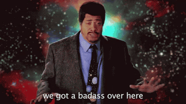 a man in a suit and tie with the words we got a badass over here below him