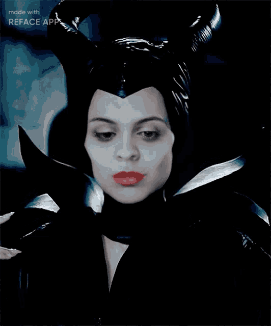 a woman in a maleficent costume is smiling with the words made with reface app below her
