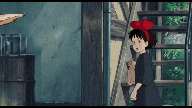 a girl with a red bow on her head stands next to a staircase