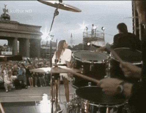 a woman is playing drums in front of a crowd and the word kultur hd is on the bottom right