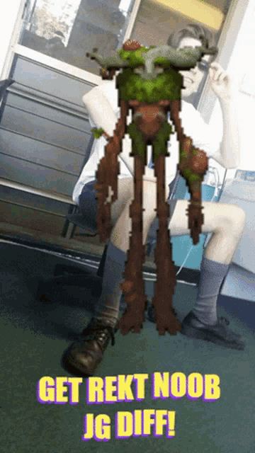 a man is sitting in a chair with a picture of a monster and the words get rekt noob jg diff