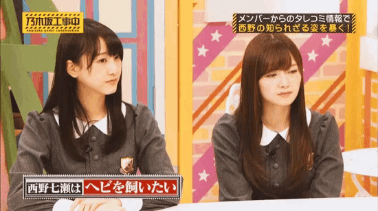 two girls are sitting next to each other and one has a sign that says ' tsn ' on it
