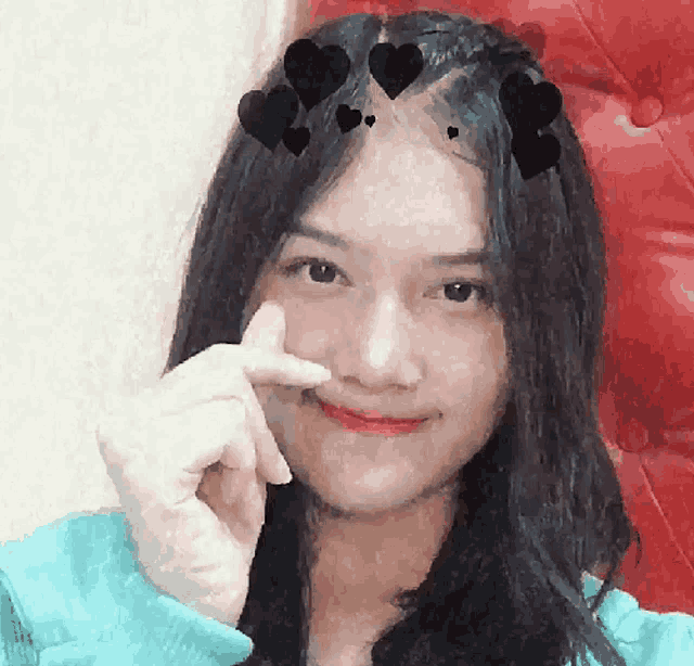 a girl with black hearts on her hair is smiling