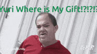 a man in a red shirt is making a funny face with the words " yuri where is my gift " above him