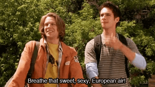 two young men are standing next to each other and one of them is saying breathe that sweet sexy european air