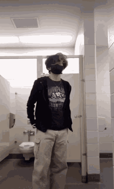 a young man wearing a black mask and a shirt that says ' apollo ' on it
