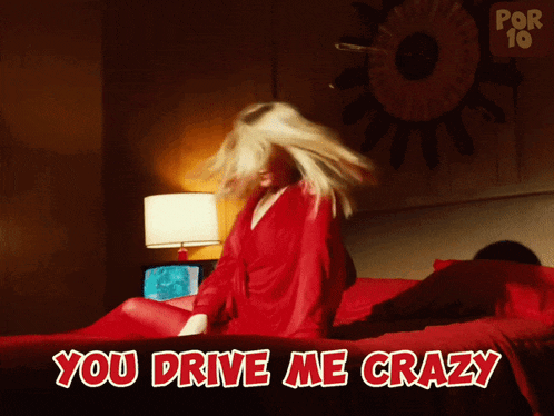a woman in a red robe is sitting on a bed with the words " you drive me crazy " above her