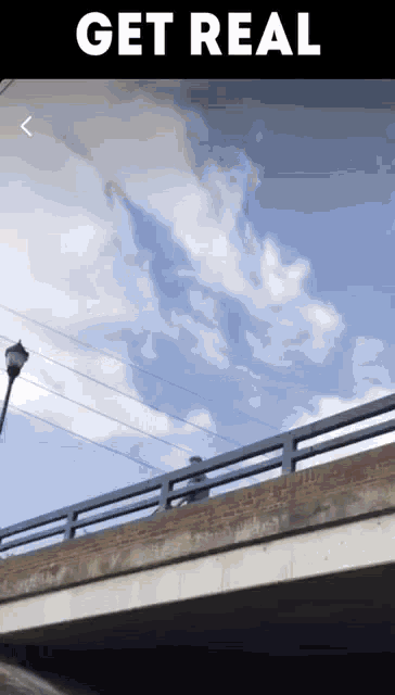 a picture of a bridge with the words " get real " on the bottom
