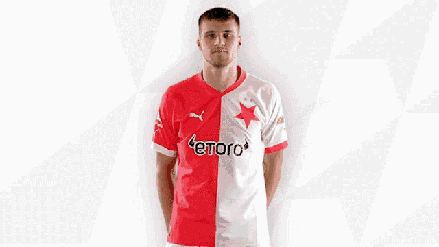 a man wearing a red and white shirt with etoro on the front