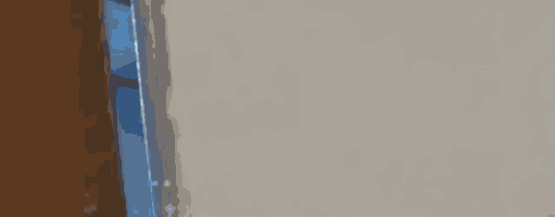 a person is standing in a room with a door open and looking through it .