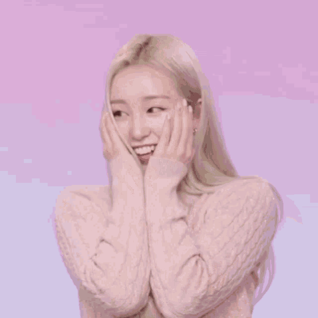 a woman is covering her face with her hands .