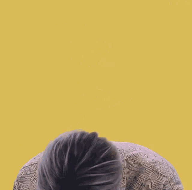 a young man is smiling with hearts surrounding him on a yellow background