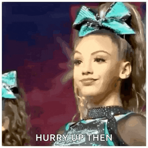 a cheerleader with a bow on her head is smiling and says hurry up then .