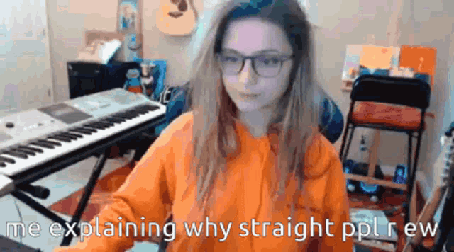 a girl wearing glasses is sitting in front of a keyboard and says me explaining why straight ppl rew
