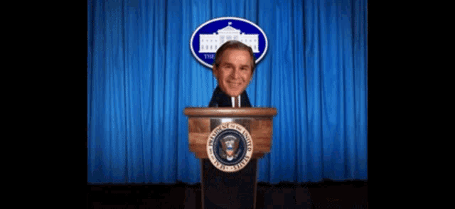 a man stands at a podium with the words " with hurricanes and terrorists " written below him