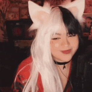 a girl wearing a cat costume with ears and a choker .