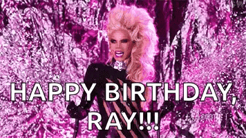 a drag queen is standing in front of a pink background and says `` happy birthday , ray !!! ''
