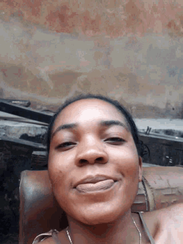 a woman is smiling with her eyes closed
