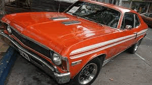 a red car is parked in a parking lot .