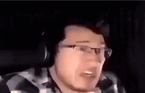 a blurry picture of a man 's face in a car