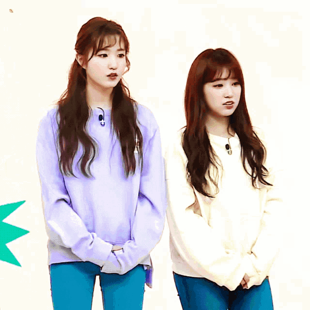 a girl in a purple sweatshirt stands next to another girl