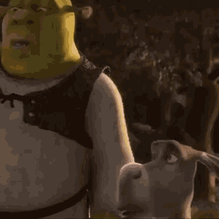 shrek from shrek is standing next to a dog in the woods .