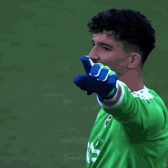 a soccer player in a green jersey with the number 1 on it