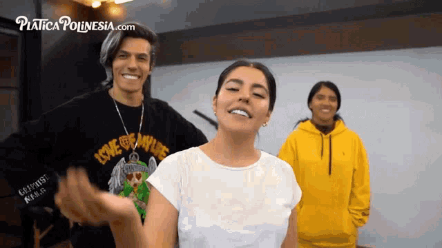 a man wearing a black shirt that says love the nature stands next to a woman in a white shirt