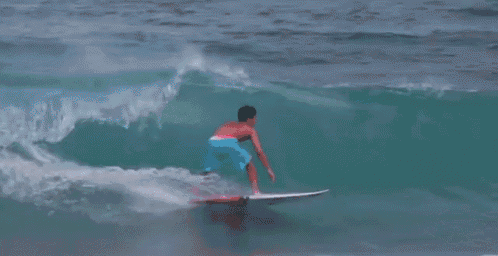 a surfer is doing a trick in the air while riding a wave with the number 8 on his surfboard