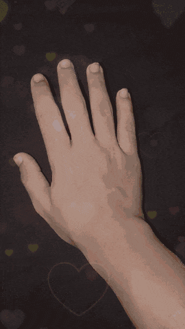 a hand with a ring on it is surrounded by hearts on a dark background