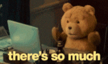 a teddy bear is sitting in front of a laptop with the words there 's so much above him