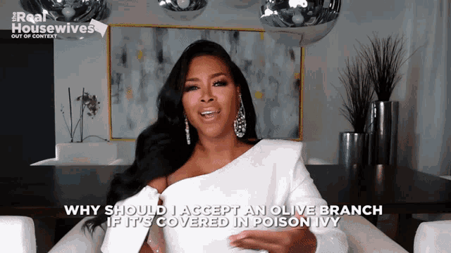 a woman in a white dress says why should i accept an olive branch